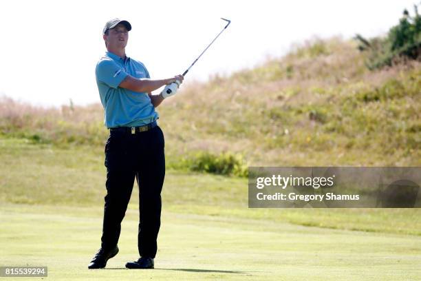 Callum Shinkwin of England hits his second shot on the 9th hole during the final round of the AAM Scottish Open at Dundonald Links Golf Course on...