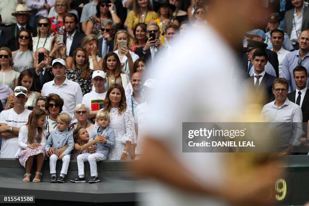 Mirka Federer, wife of Switzerland's Roger Federer, stands with her children Charlene Riva, Myla Rose, Lenny and Leo, as her husband holds the...