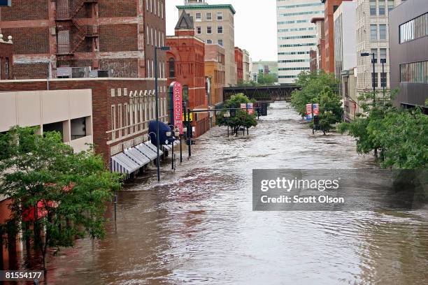 Flood water flows through downtown June 13, 2008 in Cedar Rapids, Iowa. The city continues to search for and evacuate residents as water from the...