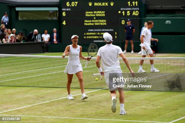 Jamie Murray of Great Britain and partner Martina Hingis of Switzerland celebrate championship point and victory during the Mixed Doubles final match...