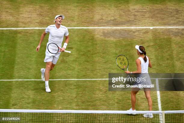 Jamie Murray of Great Britain and partner Martina Hingis of Switzerland celebrate championship point and victory during the Mixed Doubles final match...