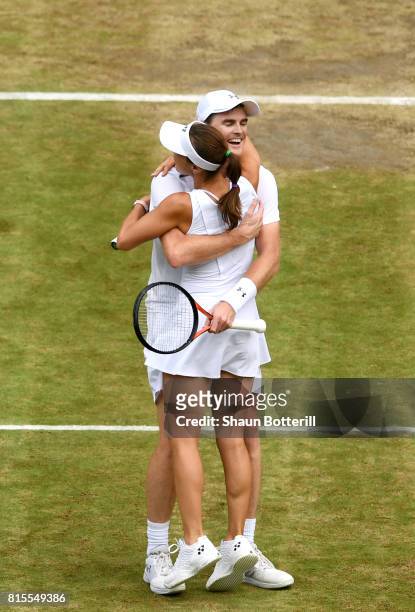 Jamie Murray of Great Britain and partner Martina Hingis of Switzerland celebrate championship point and victory during the Mixed Doubles final match...