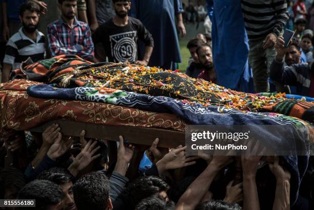 Kashmiri villagers carry the body of a local rebel Parvaiz Mir during his funeral procession, Sunday, July 16 in Pohoo village 38 kilometers south of...