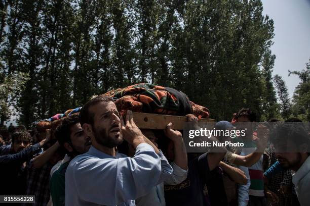 Kashmiri villagers carry the body of a local rebel Parvaiz Mir during his funeral procession, Sunday, July 16 in Pohoo village 38 kilometers south of...