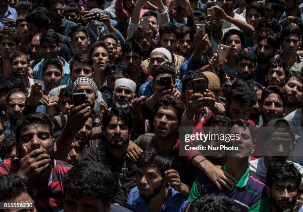 Kashmiri villagers react after looking at the body of a local rebel Parvaiz Mir during his funeral, Sunday, July 16 in Pohoo village 38 kilometers...