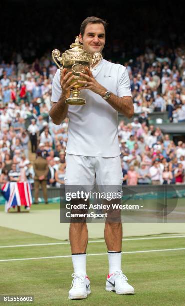 Roger Federer of Switzerland celebrates with the trophy after his defeat of Marin Cilic of Croatia in their Gentlemen's Singles Final at Wimbledon on...