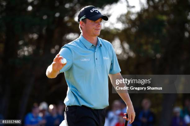 Callum Shinkwin of England acknowledges the crowd on the 16th green during the final round of the AAM Scottish Open at Dundonald Links Golf Course on...