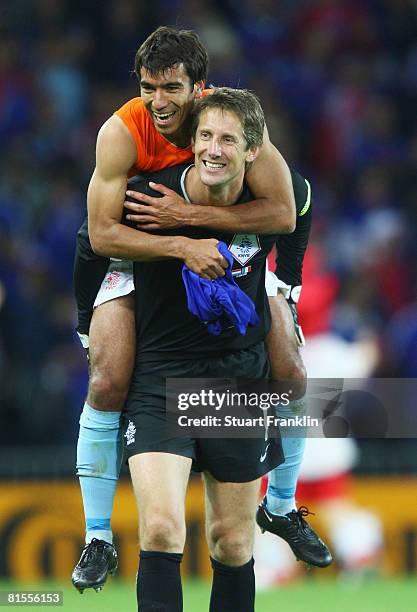 Goalkeeper Edwin van der Sar of Netherlands and team mate Giovanni van Bronckhorst celebrate victory after the UEFA EURO 2008 Group C match between...