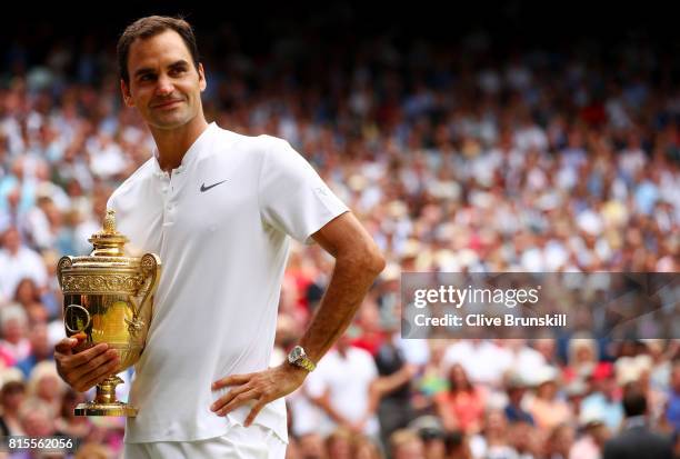 Roger Federer of Switzerland celebrates victory with the trophy after the Gentlemen's Singles final against Marin Cilic of Croatia on day thirteen of...