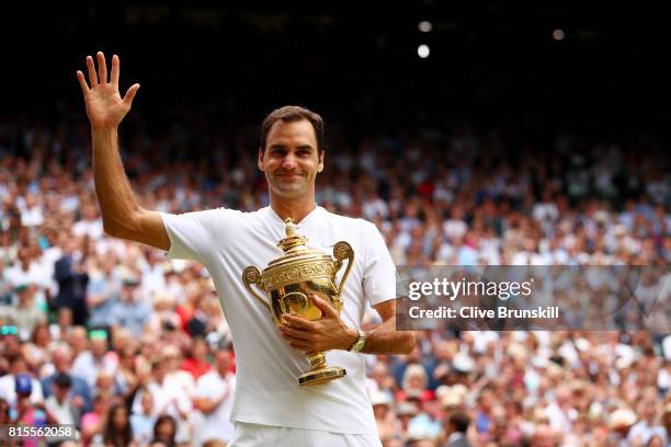 Roger Federer of Switzerland celebrates victory with the trophy after the Gentlemen's Singles final against Marin Cilic of Croatia on day thirteen of...