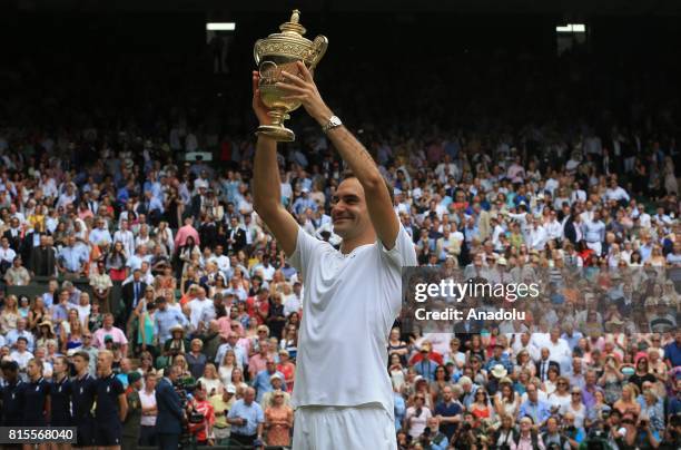 Roger Federer of Switzerland celebrates with the winner's trophy after beating Marin Cilic of Croatia in the men's final of the 2017 Wimbledon...