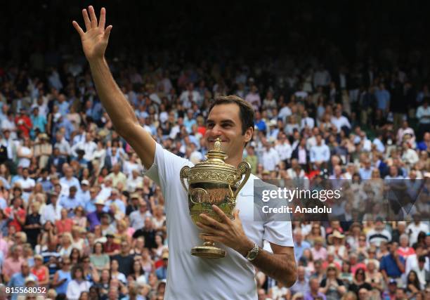 Roger Federer of Switzerland celebrates with the winner's trophy after beating Marin Cilic of Croatia in the men's final of the 2017 Wimbledon...