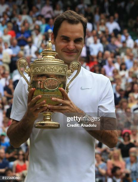 Roger Federer of Switzerland celebrates with the winner's trophy after beating Marin Cilic of Croatia in the men's final of the 2017 Wimbledon...