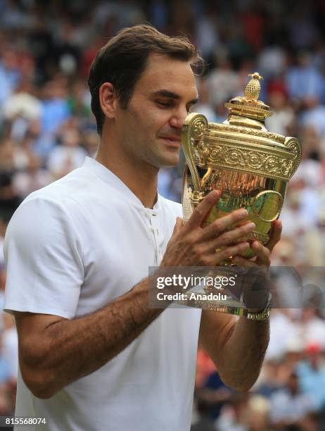 Roger Federer of Switzerland celebrates with the winner's trophy after beating Marin Cilic of Croatia in the men's final of the 2017 Wimbledon...