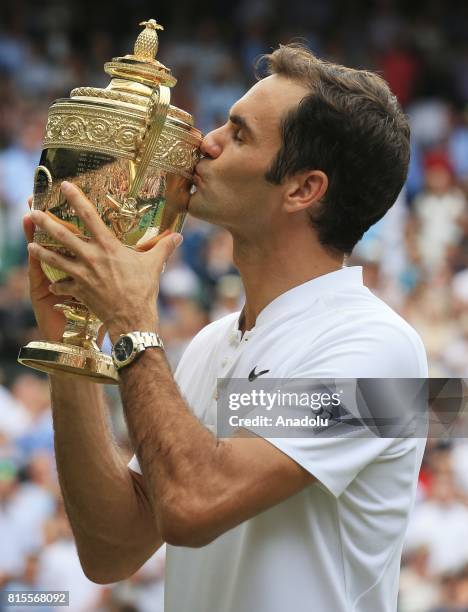 Roger Federer of Switzerland celebrates with the winner's trophy after beating Marin Cilic of Croatia in the men's final of the 2017 Wimbledon...