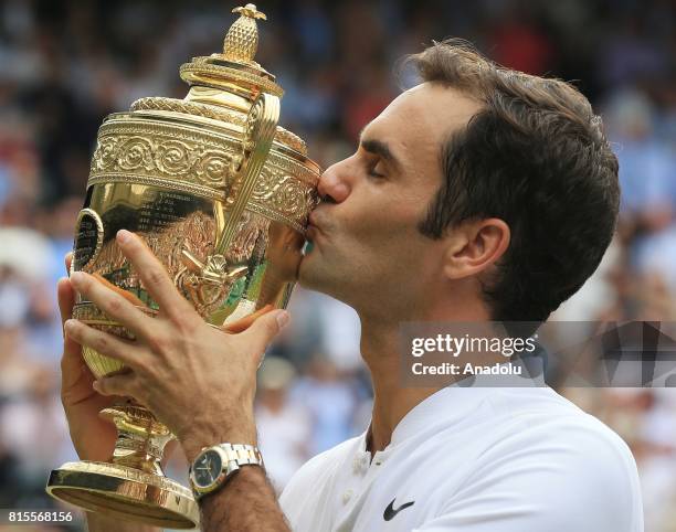 Roger Federer of Switzerland celebrates with the winner's trophy after beating Marin Cilic of Croatia in the men's final of the 2017 Wimbledon...