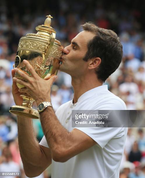 Roger Federer of Switzerland celebrates with the winner's trophy after beating Marin Cilic of Croatia in the men's final of the 2017 Wimbledon...