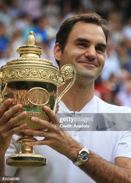 Roger Federer of Switzerland celebrates with the winner's trophy after beating Marin Cilic of Croatia in the men's final of the 2017 Wimbledon...