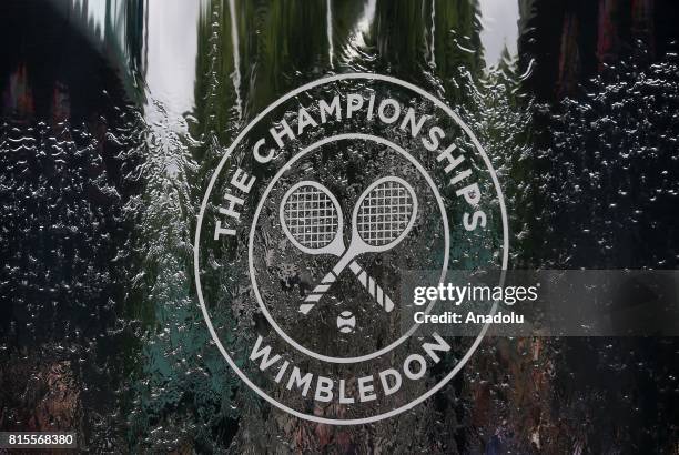 The iconic Wimbledon logo at the main entrance to the stadium where Marin Cilic of Croatia in action against Roger Federer of Switzerland in the...