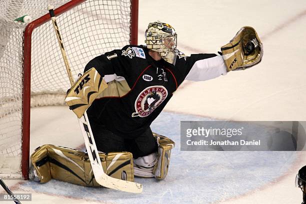 John Curry of the Wilkes-Barre/Scranton Penguins reaches for the puck against the Chicago Wolves during the Calder Cup Finals on June 10, 2008 at the...