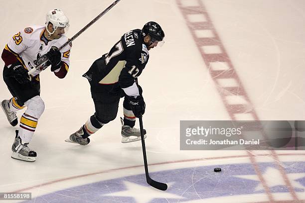 Kurtis McLean of the Wilkes-Barre/Scranton Penguins moves for the puck against Colin Stuart of the Chicago Wolves during the Calder Cup Finals on...
