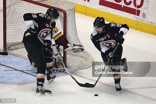 Conner James and Luca Caputi of the Wilkes-Barre/Scranton Penguins handle the puck against the Chicago Wolves during the Calder Cup Finals on June...