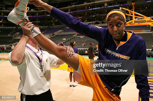 Candace Parker of the Los Angeles Sparks is stretched out by a trainer before the game against the Connecticut Sun at Staples Center on June 13, 2008...