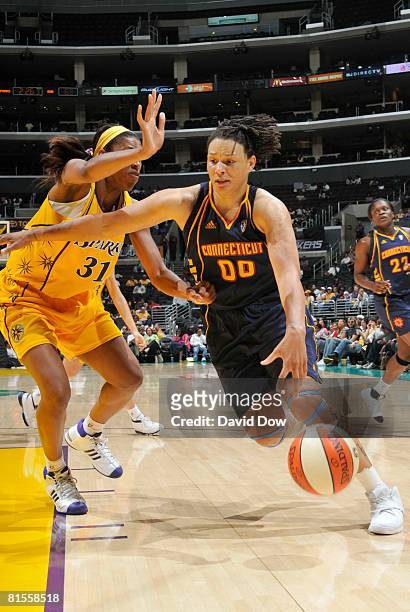 Tamika Whitmore of the Connecticut Sun drives along the baseline against Jessica Moore of the Los Angeles Sparks at Staples Center on June 13, 2008...