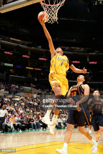 Candace Parker of the Los Angeles Sparks goes up for a layup while Tamika Whitmore of the Connecticut Sun looks on during their game at Staples...