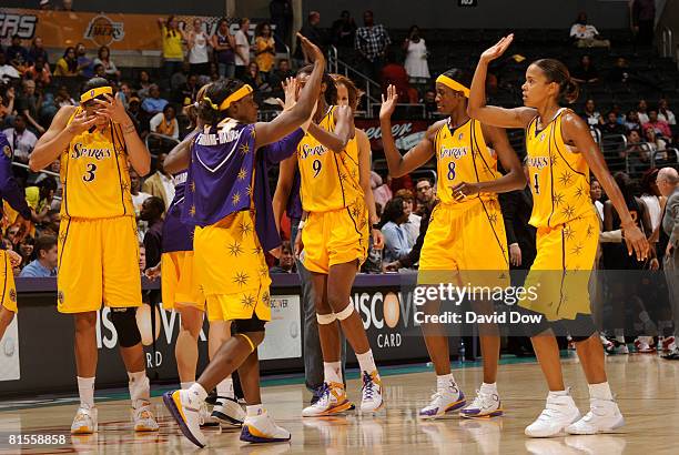 Marie Ferdinand-Harris congratulates teammates Lisa Leslie, DeLisha Milton-Jones, and Keisha Brown following their victory over the Connecticut Sun...