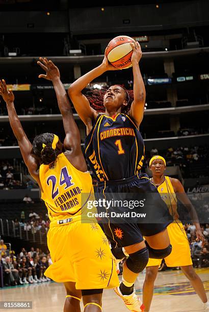 Amber Holt of the Connecticut Sun goes up for a shot against Marie Ferdinand-Harris of the Los Angeles Sparks at Staples Center on June 13, 2008 in...