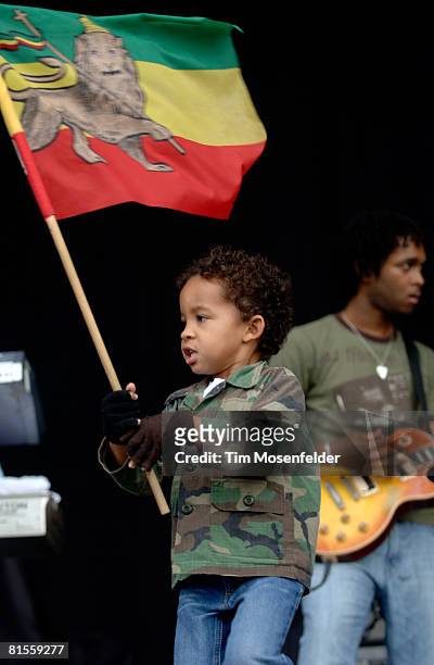 Young flag waver joins Stephen Marley as he performs as part of the Bonnaroo Music Festival on June 13, 2008 in Manchester, Tennessee.