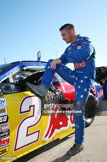 Scott Speed driver of the Red Bull Toyota gets into his car priot to the start of the ARCA RE/MAX Series Racing for Wildlife 200 at the Michigan...