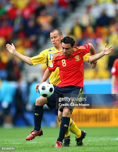 Daniel Andersson of Sweden battles for the ball with Xavi Hernandez of Spain during the UEFA EURO 2008 Group D match between Sweden and Spain at...