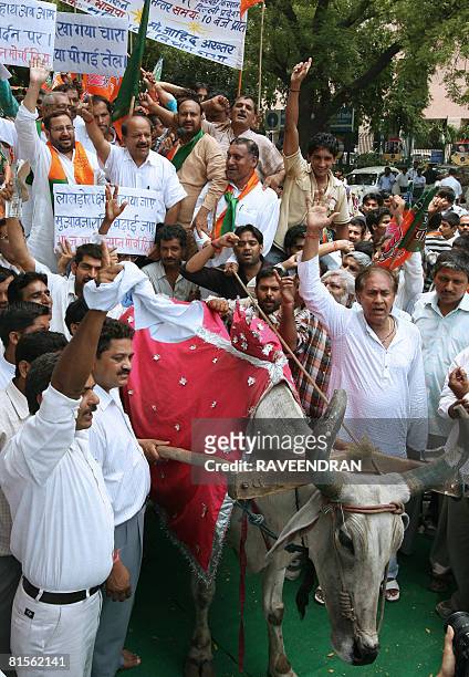 India's main opposition Bharatiya Janata Party Delhi president Harsh Vardhan and BJP supporters ride on a bullock cart and shout anti-Congress-led...