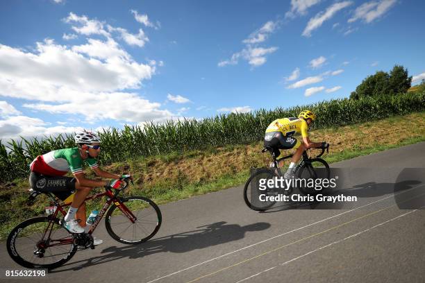 Christopher Froome of Great Britain riding for Team Sky in the leader's jersey and Fabio Aru of Italy riding for Astana Pro Team ride in the peloton...
