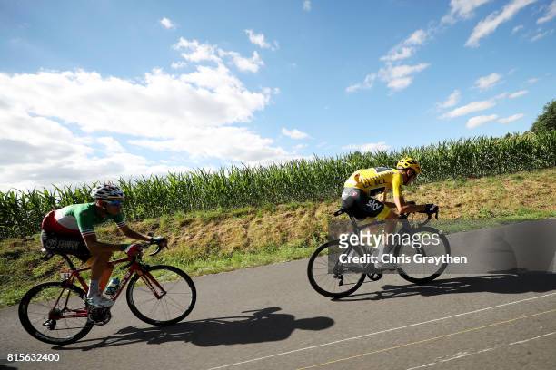 Christopher Froome of Great Britain riding for Team Sky in the leader's jersey and Fabio Aru of Italy riding for Astana Pro Team ride in the peloton...