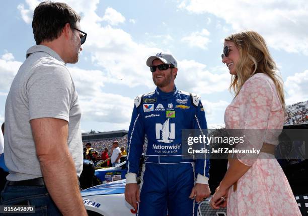 Dale Earnhardt Jr. , driver of the Nationwide Chevrolet, and his wife Amy speak with former NASCAR driver Jeff Gordon on the grid prior to the...