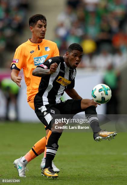 Benjamin Huebner challenges Kwame Yeboah of Moenchengladbach during the Telekom Cup 2017 3rd place match between Borussia Moenchengladbach and TSG...