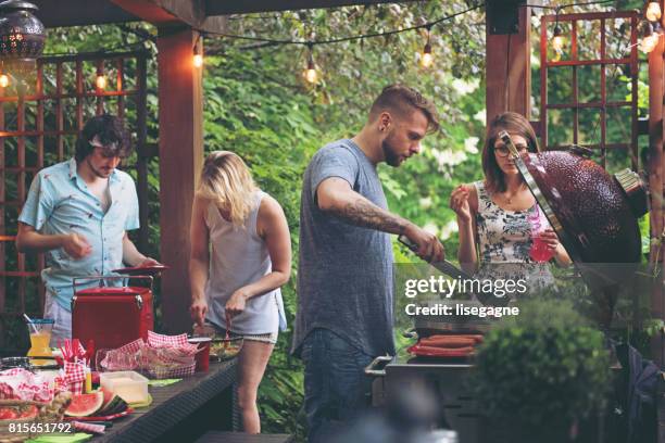 friends during a summer day - garden barbecue stock pictures, royalty-free photos & images