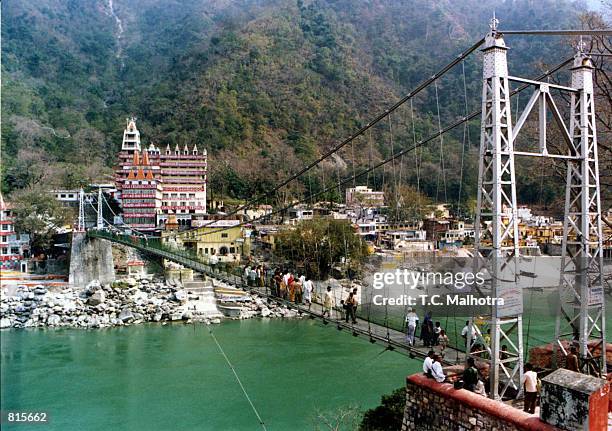 The hanging bridge, Luxman Jhulaover, over the mighty river of Ganges near the historic site of Rishikesh a few kilometres away from the holy city of...