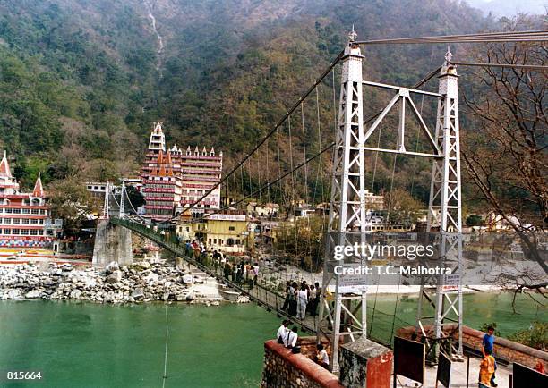 The hanging bridge, Luxman Jhulaover, over the mighty river of Ganges near the historic site of Rishikesh a few kilometres away from the holy city of...