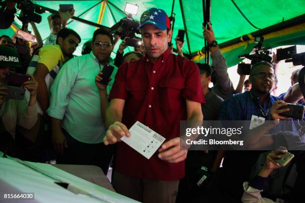 Henrique Capriles, opposition leader and governor of the State of Miranda, casts a ballot at a polling station during a symbolic plebiscite in...