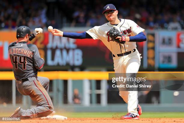 Freddie Freeman of the Atlanta Braves turns a double play over Paul Goldschmidt of the Arizona Diamondbacks during the sixth inning at SunTrust Park...