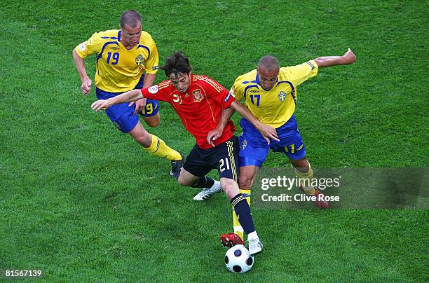 David Silva of Spain is challenged by Daniel Andersson and Henrik Larsson of Sweden during the UEFA EURO 2008 Group D match between Sweden and Spain...