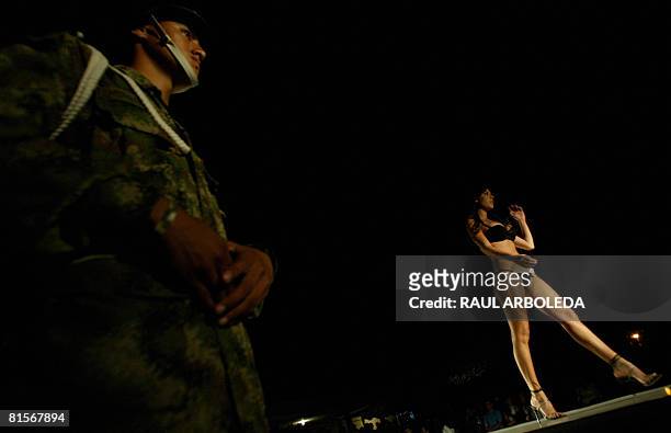 Model presents a creation by fashion designer Adriana Arango of Colombia's brand "Besame" at the fourth brigade of Colombian Army on June 13, 2008 in...