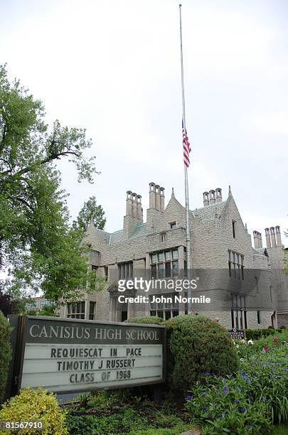 Workers lower the flag to half mast in honor of journalist Tim Russert at Canisus high Scool where he attended school on Flag day June 14, 2008 in...