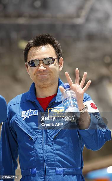 Japanese astronaut Akihiko Hoshide waves following the landing of the US space shuttle Discovery at the Kennedy Space Center in Florida on June 14,...