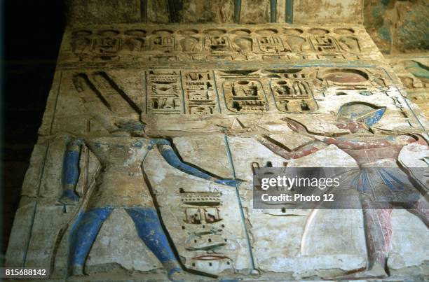 Amon-Ra, Egyptian god, and Rameses III second king of 20th dynasty. Painted relief, temple of Rameses II, Medinet Habu. Ankh held by Amon-Ra. Empty...