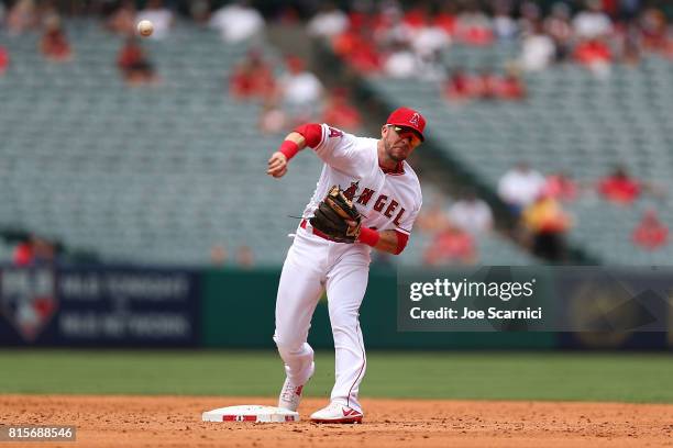 Nick Franklin of the Los Angeles Angels throws to first getting out Malex Smith of the Tampa Bay Rays resulting in a double play in the third inning...